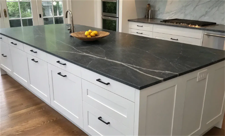 Modern white kitchen island with dark veined soapstone indoor countertop