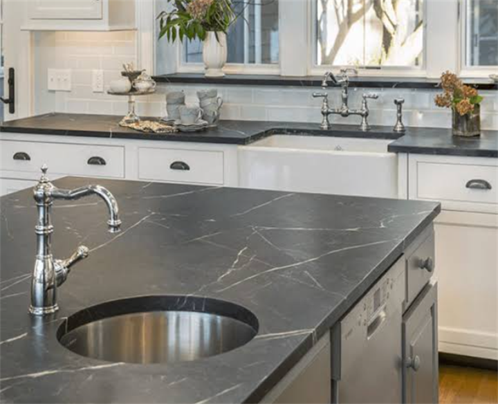 Traditional home kitchen featuring soapstone countertops with integrated sink