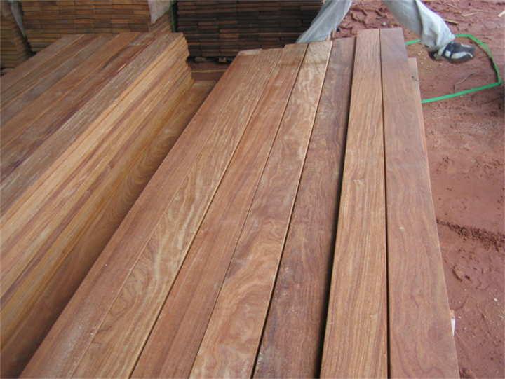 Stacked raw Brazilian teak Ipe hardwood decking planks at construction lumber yard
