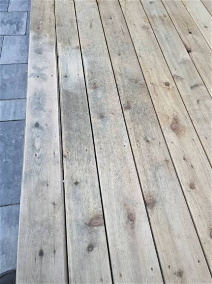 Unfinished softwood deck lumber prone to tannin bleed, common issue on Maine coastal wooden decks