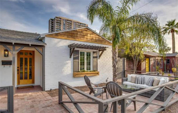 Phoenix adobe-style cottage front courtyard with shaded patio and desert vegetation