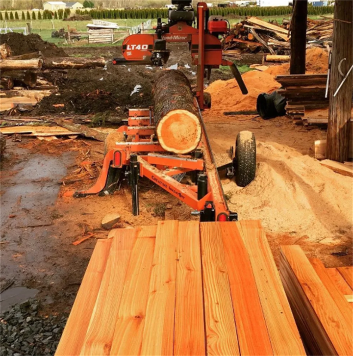 Portable LT40 sawmill cutting Western Red Cedar logs into cedar planks at a Pacific Northwest small local sawmill