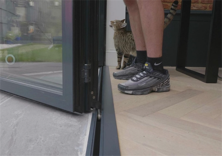 Low threshold bifold door, showing tripping hazard gap between indoor flooring and patio