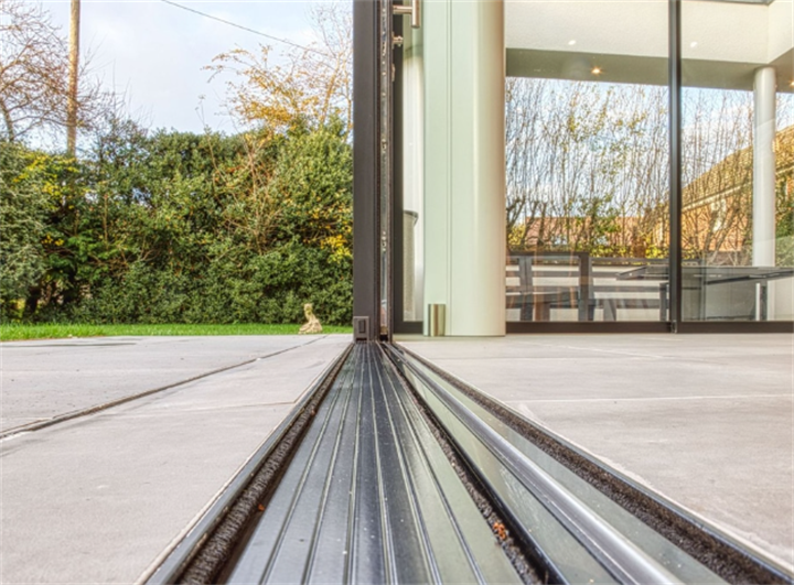 Sleek flush threshold track for aluminium folding doors creating level indoor-outdoor transition