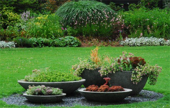 Layered concrete planters used to disguise a backyard septic mound area