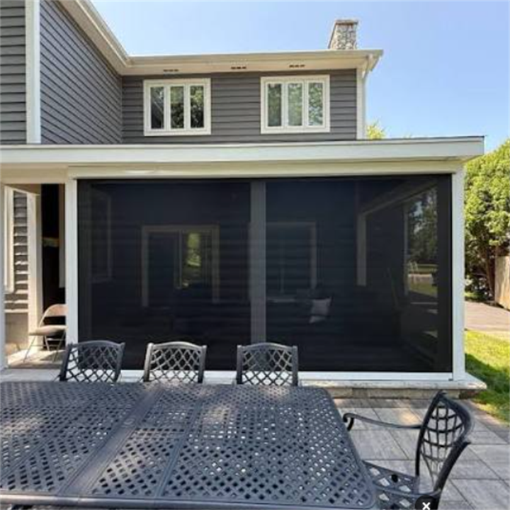 Retractable mesh screen enclosure transforming back patio into a bug-free screened dining porch